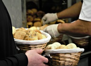 Close-up of fresh bread in woven baskets at a bakery. Perfect for food and business themes.